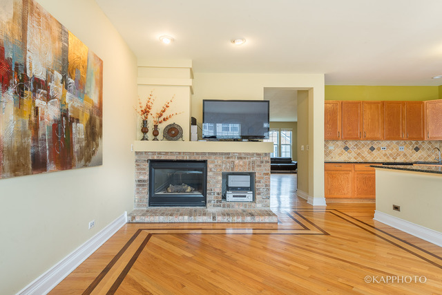 1270 Georgetown Way Vernon Hills, IL 60061 - Photo 11 of 25 a living room with stainless steel appliances kitchen island granite countertop furniture and a fireplace