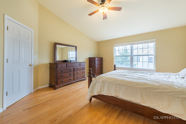 1270 Georgetown Way Vernon Hills, IL 60061 - Photo 17 of 25 a bedroom with a bed and wooden floor
