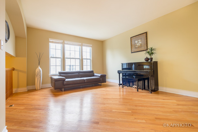 1270 Georgetown Way Vernon Hills, IL 60061 - Photo 3 of 25 a living room with furniture and a dining table with wooden floor