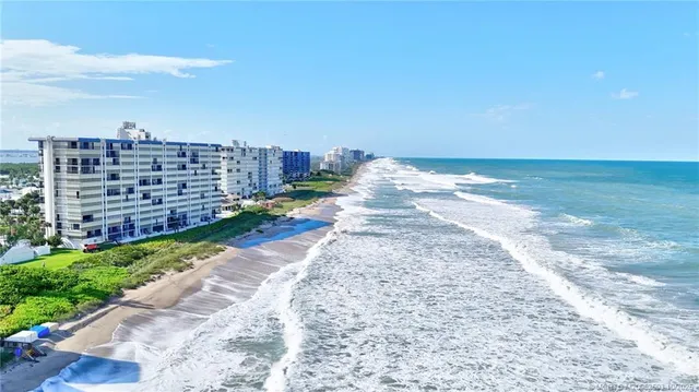 a view of a beach with a building in the background