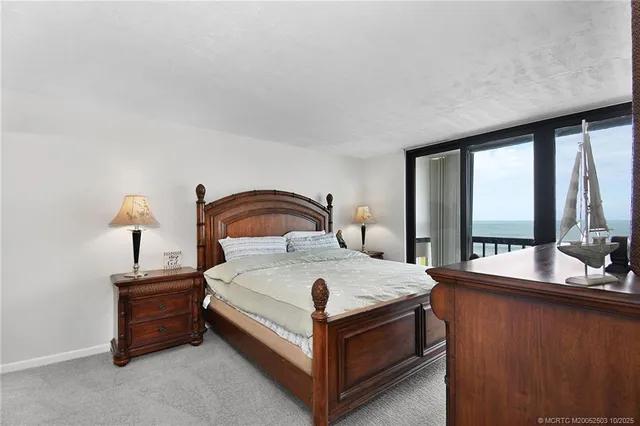 a bedroom with a bed and a lamp