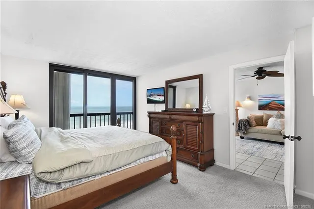 a bathroom with a granite countertop sink a mirror a shower and a toilet