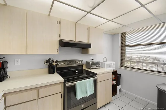 a view of a dining room with furniture and a potted plant