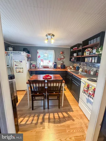 a dining area with furniture and a rug