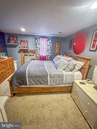 a bedroom with a bed and dresser