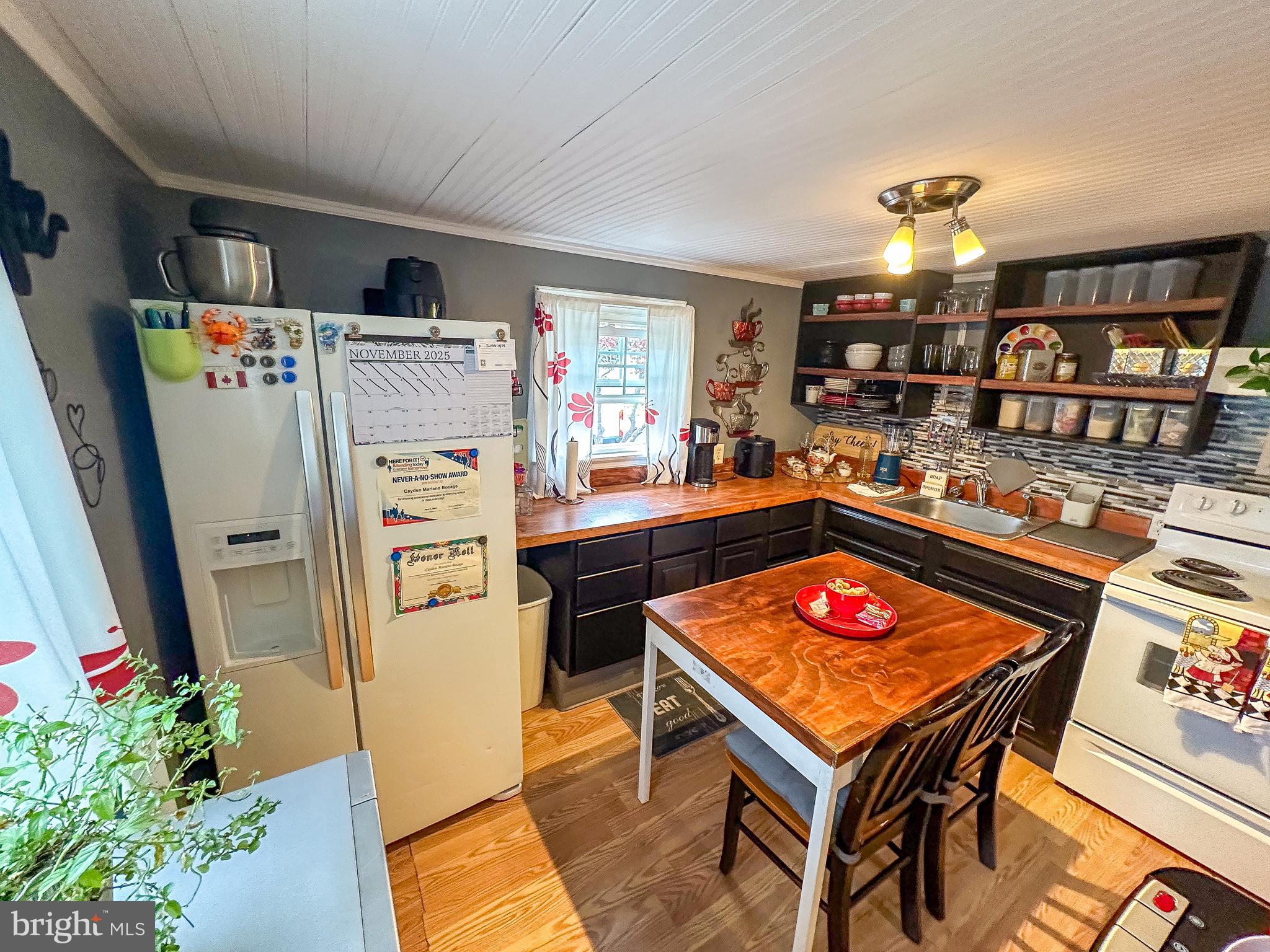 112 Trailway Road Middle River, MD 21220 - Photo 2 of 32 a kitchen with stainless steel appliances granite countertop table chairs and a living room