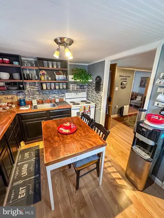 a room with stainless steel appliances kitchen island granite countertop a stove and cabinets