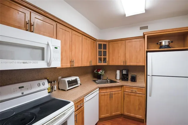 a kitchen with stainless steel appliances a stove a refrigerator and a sink