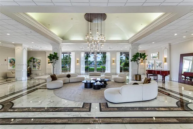 a living room with fireplace furniture and a chandelier