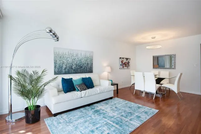 a living room with furniture rug and window