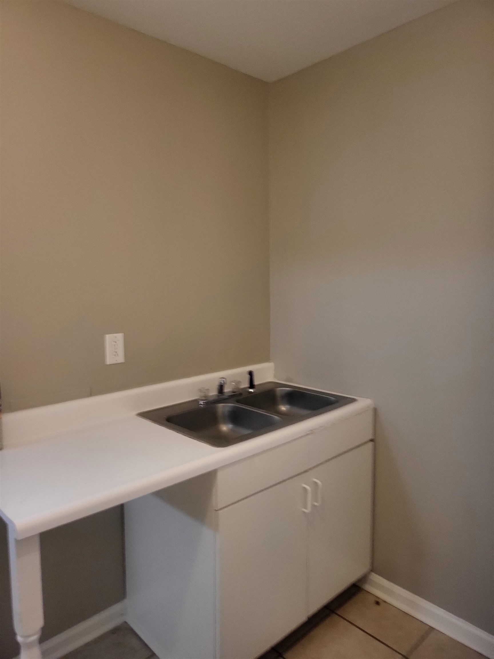 1769 Capri Street Memphis, TN 38117 - Photo 13 of 19 Washroom with light tile patterned floors and a sink