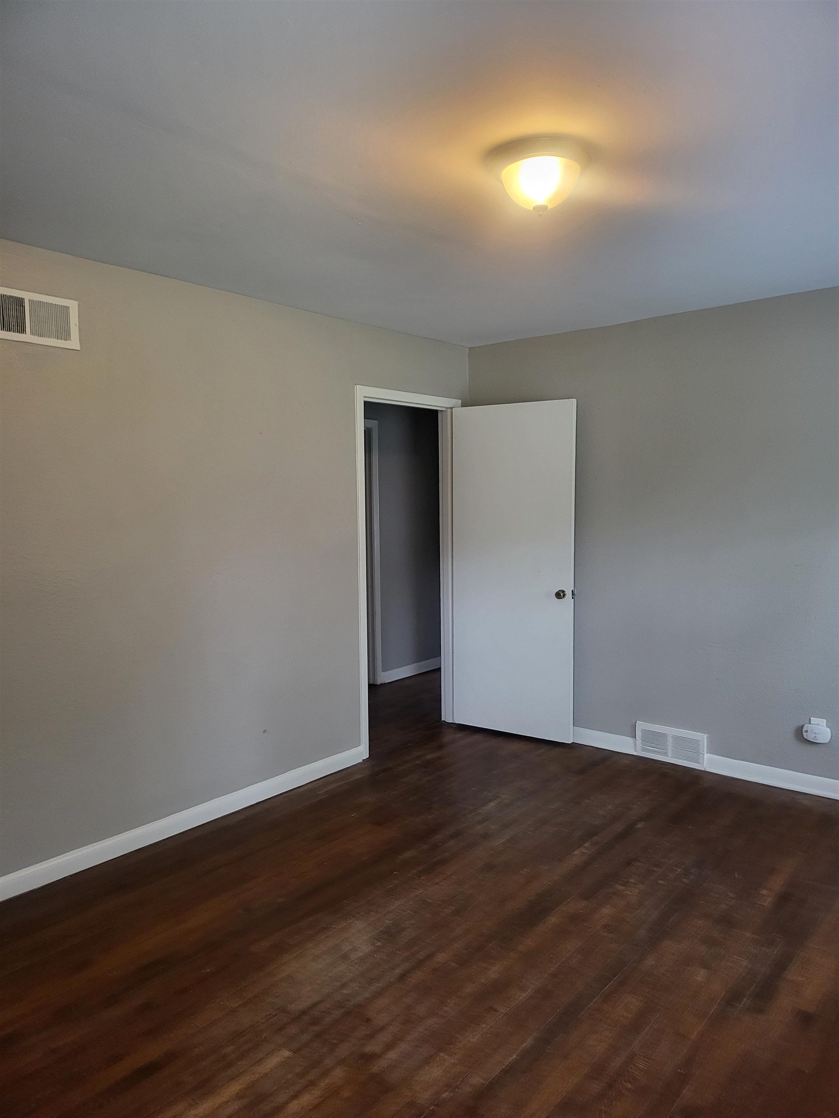1769 Capri Street Memphis, TN 38117 - Photo 3 of 19 Spare room with dark wood-type flooring and baseboards