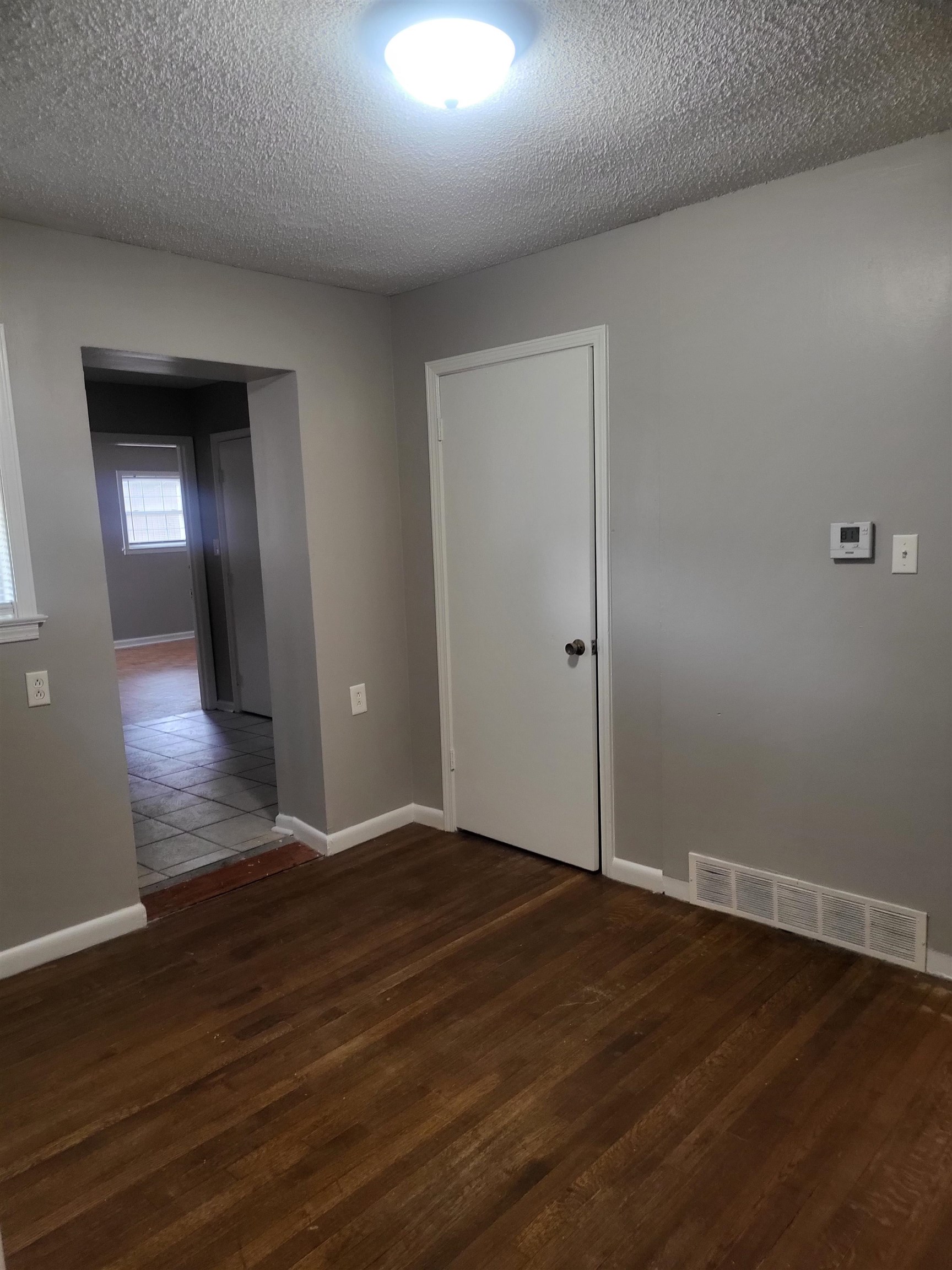 1769 Capri Street Memphis, TN 38117 - Photo 6 of 19 Empty room with a textured ceiling and dark wood finished floors