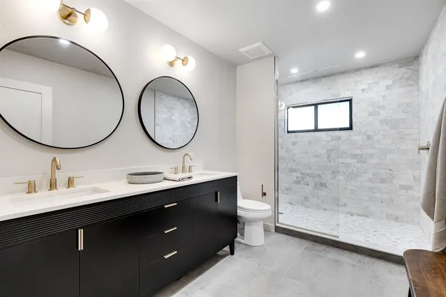 a bathroom with a double vanity sink and a mirror