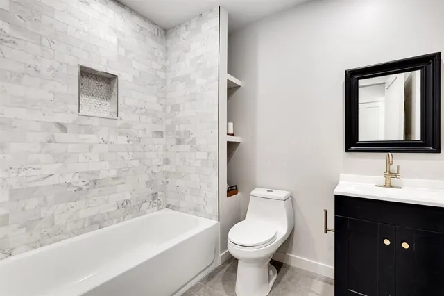 a bathroom with a toilet a sink and bathtub