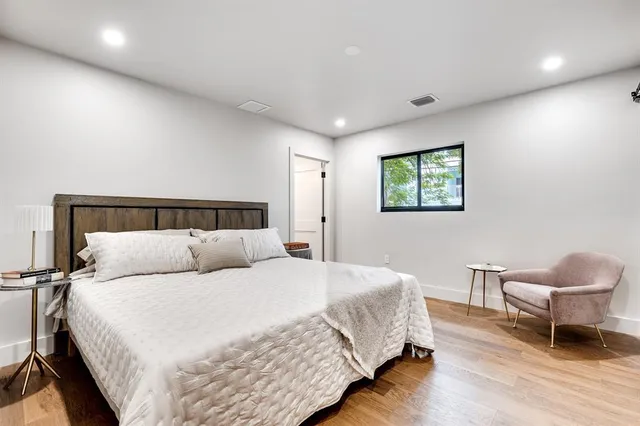 a bedroom with a bed and a chair