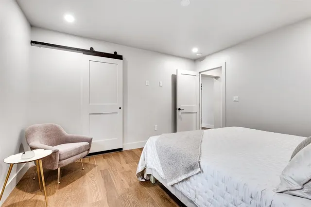 a bedroom with a bed and a chair