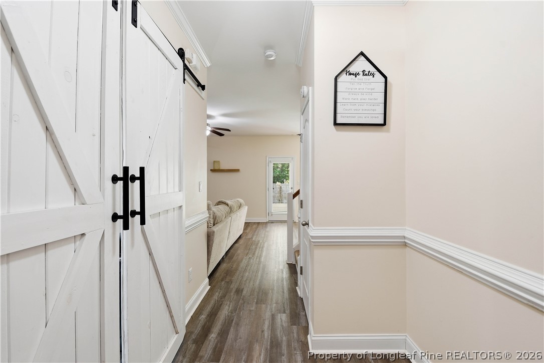140 Birch Avenue Spring Lake, NC 28390 - Photo 13 of 49 a view of a hallway with wooden floor and staircase