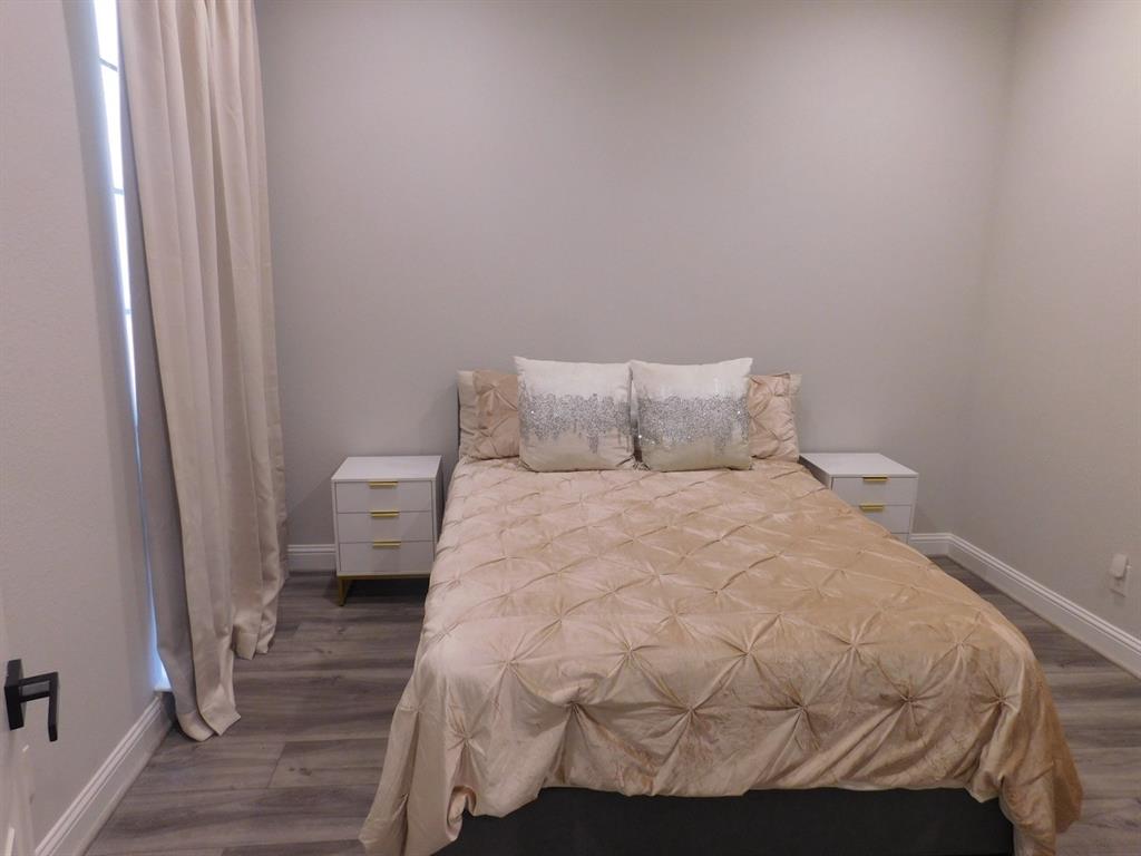 622 Crowley Road Arlington, TX 76012 - Photo 18 of 38 a bedroom with a bed and wooden floor