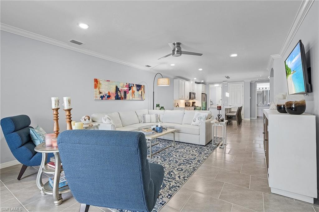 14618 Edgewater Circle Naples, FL 34114 - Photo 16 of 30 Living room with ceiling fan, ornamental molding, and light tile patterned floors