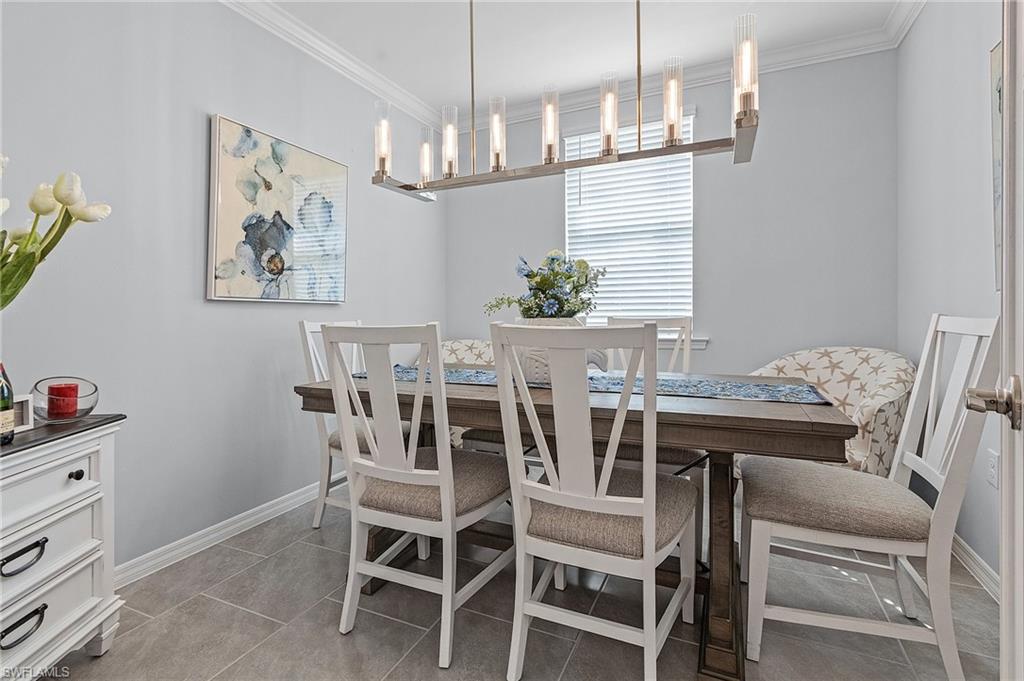 14618 Edgewater Circle Naples, FL 34114 - Photo 19 of 30 Tiled dining space with ornamental molding and a chandelier