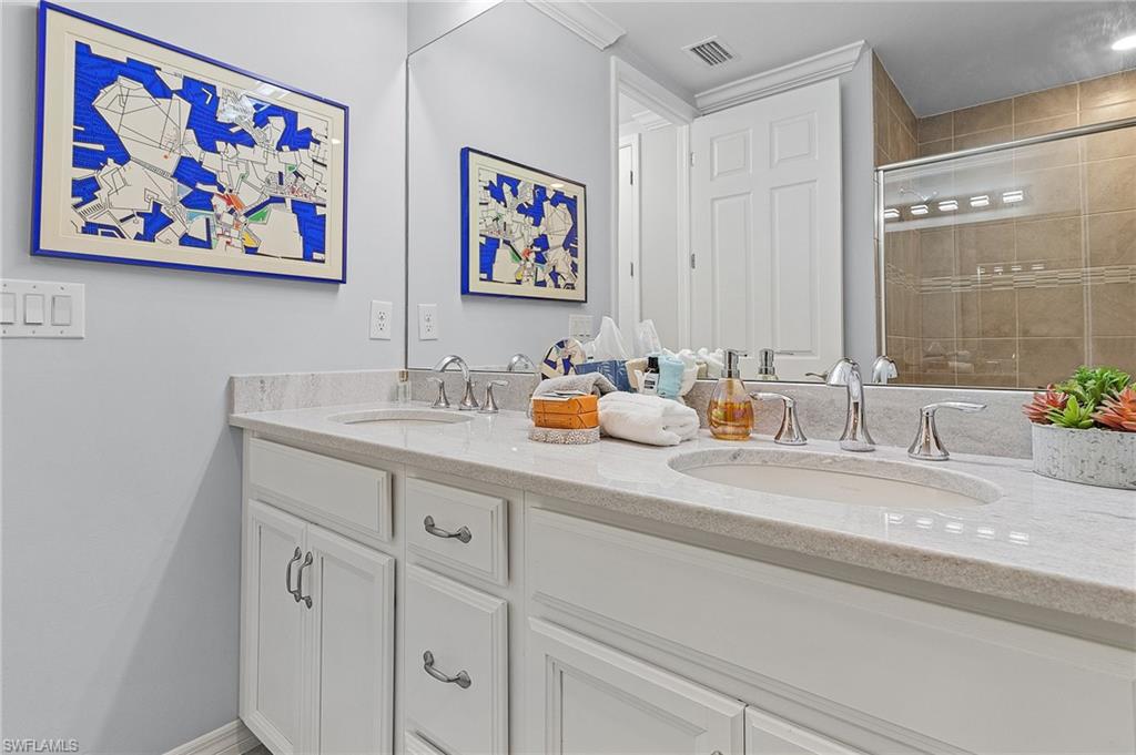 14618 Edgewater Circle Naples, FL 34114 - Photo 21 of 30 Bathroom with a shower with door and vanity