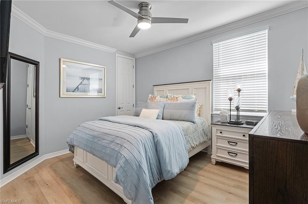 14618 Edgewater Circle Naples, FL 34114 - Photo 23 of 30 Bedroom featuring ceiling fan, light hardwood / wood-style floors, and crown molding