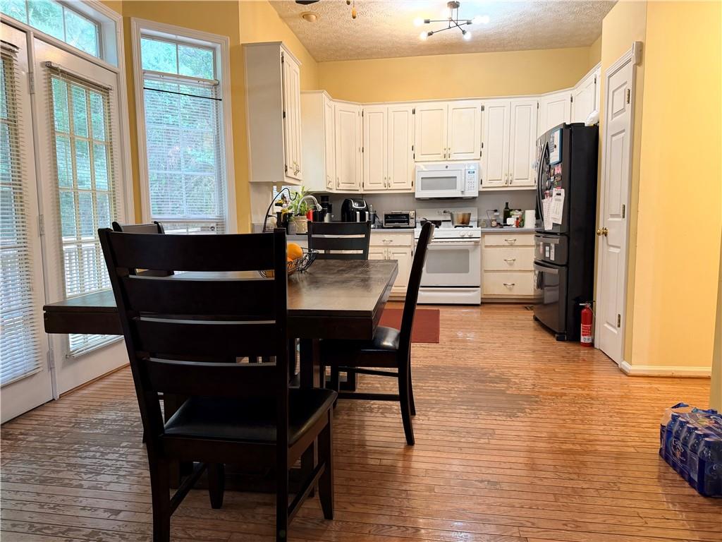426 Pates Lake Court Hampton, GA 30228 - Photo 11 of 60 a view of a dining room with furniture and wooden floor