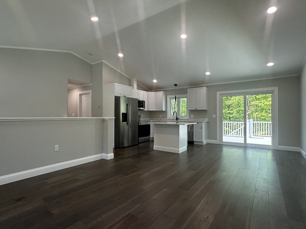 102 Wells Road Becket, MA 01223 - Photo 11 of 40 an open kitchen with kitchen island wooden floors appliances and center island