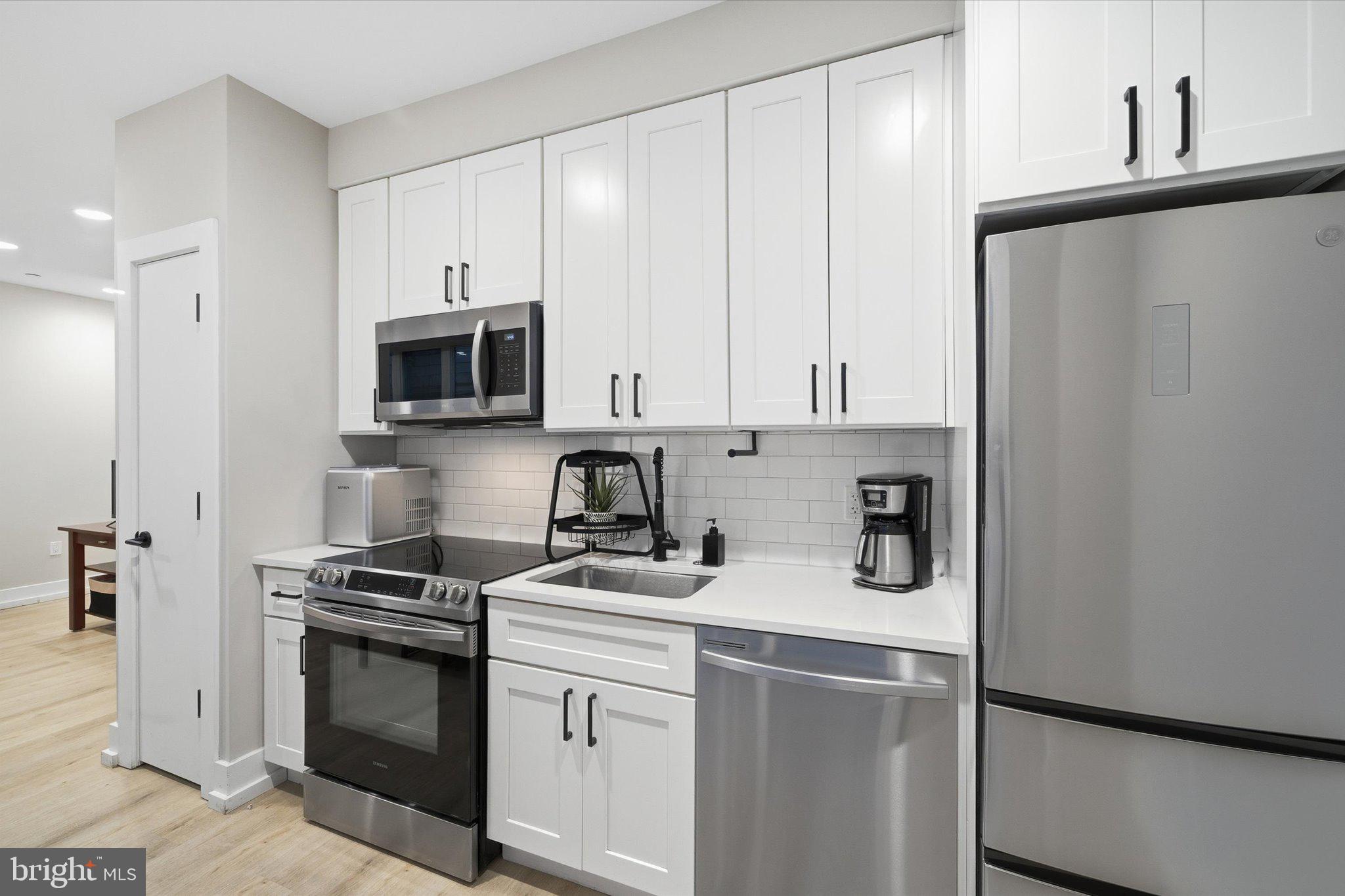 1016 17th Place Northeast, Unit 7 Washington, DC 20002 - Photo 10 of 28 a kitchen with stainless steel appliances a refrigerator stove and microwave