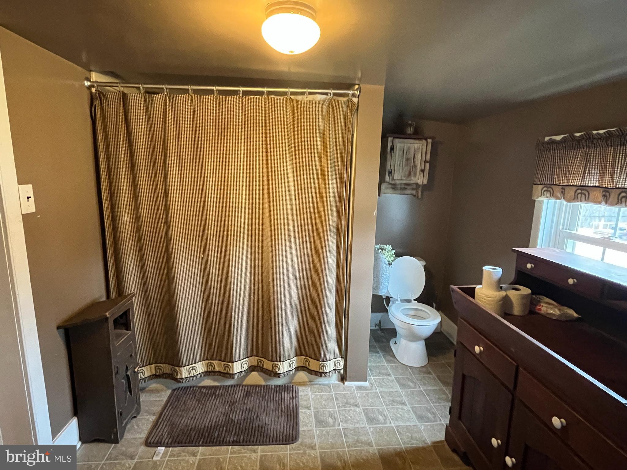 2 West High Street McClure, PA 17841 - Photo 23 of 40 a bathroom with a sink a toilet and shower