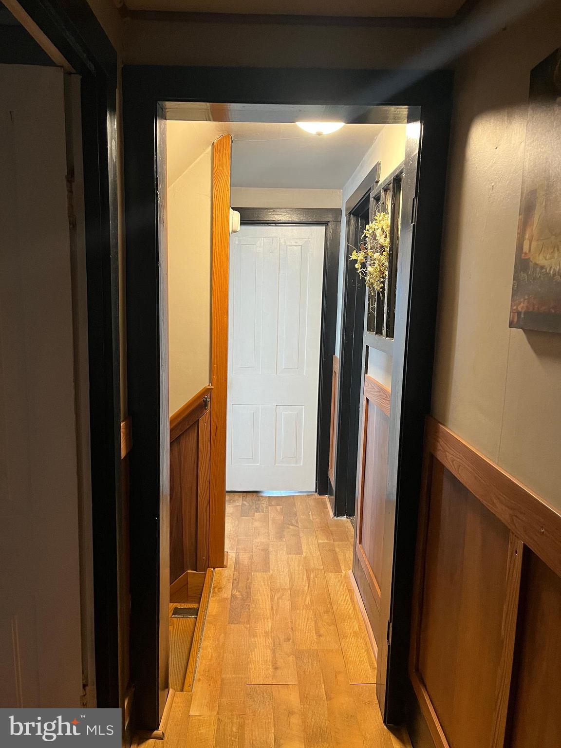 2 West High Street McClure, PA 17841 - Photo 26 of 40 a hallway with sliding door and wooden floor