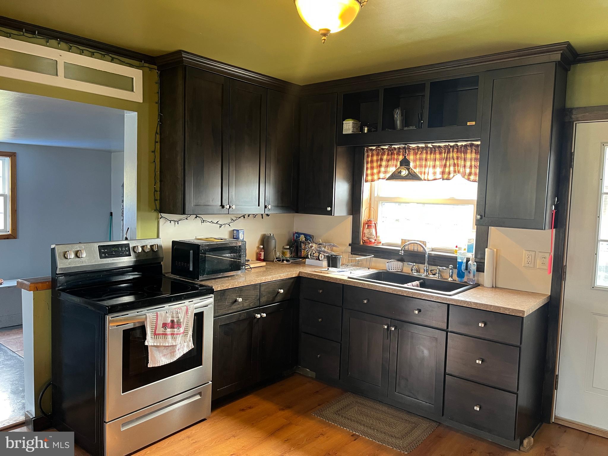 2 West High Street McClure, PA 17841 - Photo 9 of 40 a kitchen with a sink stove and cabinets