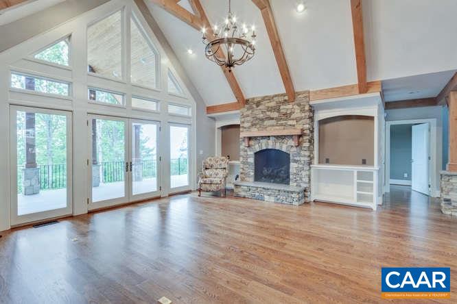 2474 Summit Ridge Trail Charlottesville, VA 22911 - Photo 5 of 16 a view of an empty room with wooden floor and a fireplace