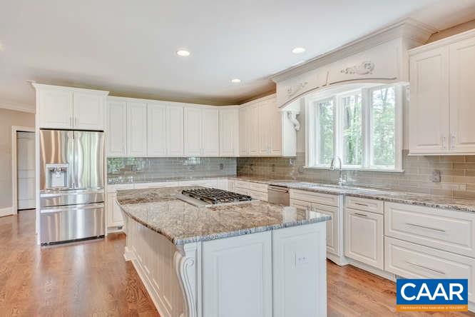 2474 Summit Ridge Trail Charlottesville, VA 22911 - Photo 8 of 16 a kitchen with a stove a sink a refrigerator and white cabinets with wooden floor