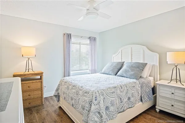 a bedroom with a bed and a lamp on dresser