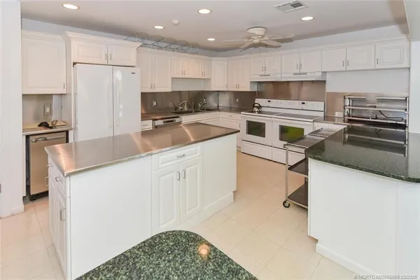 a kitchen with a sink stainless steel appliances and cabinets