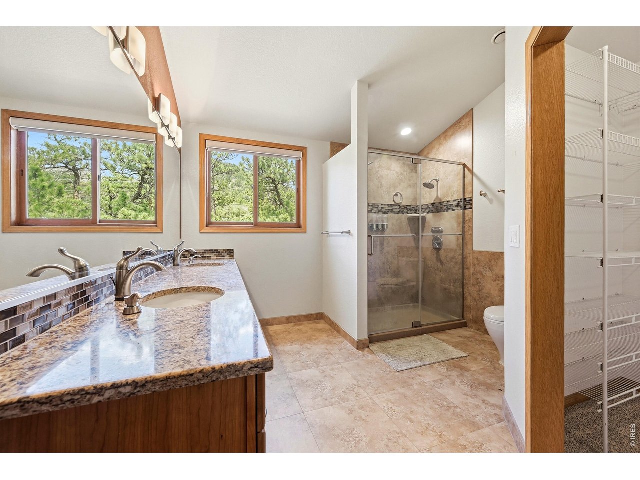 256 Choctaw Road Lyons, CO 80540 - Photo 29 of 50 a bathroom with a granite countertop sink a shower and a mirror