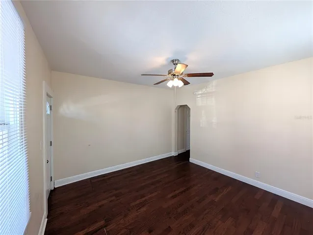 a view of an empty room with wooden floor