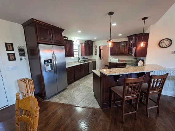 a kitchen with a sink stove top oven and refrigerator