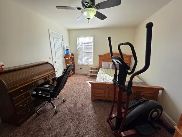 a bedroom with furniture and a window