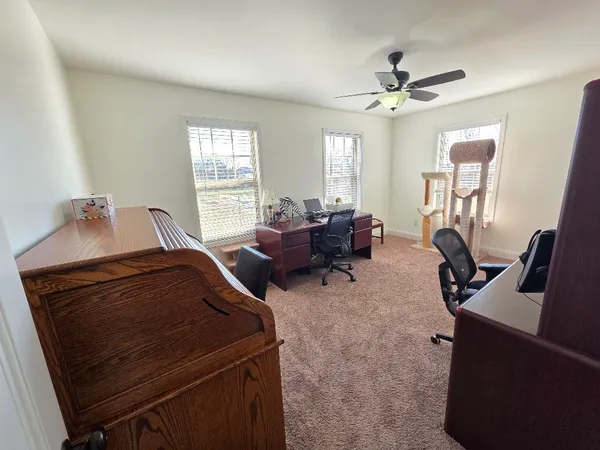 a view of a livingroom with furniture and a window