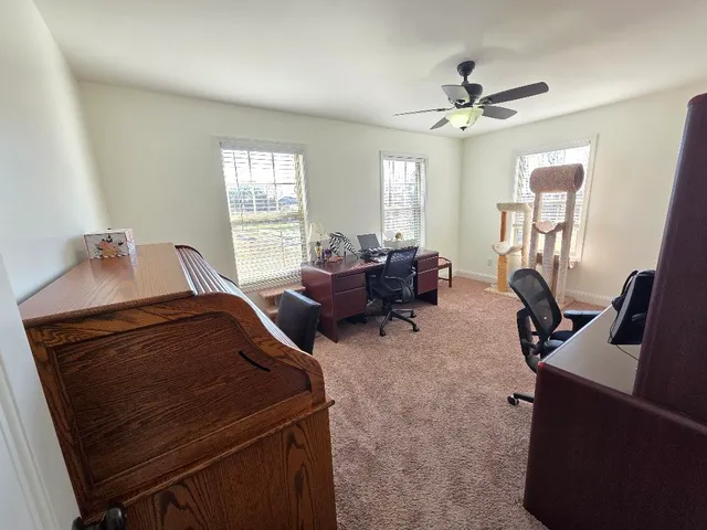 a view of a livingroom with furniture and a window