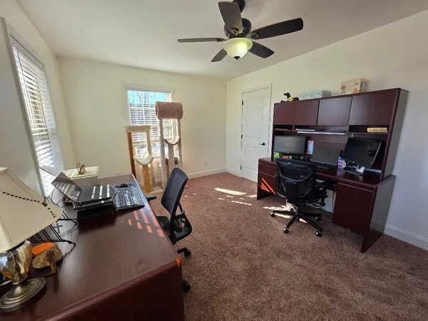 a dining room with furniture and wooden floor