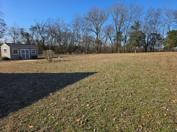 a front view of a house with a yard and mountain view
