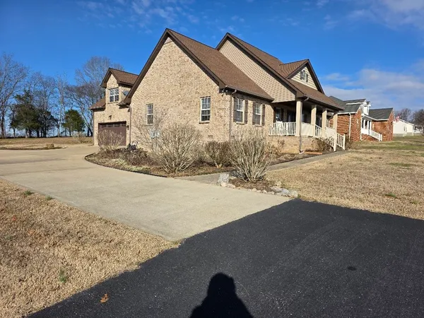 a view of house with yard and trees