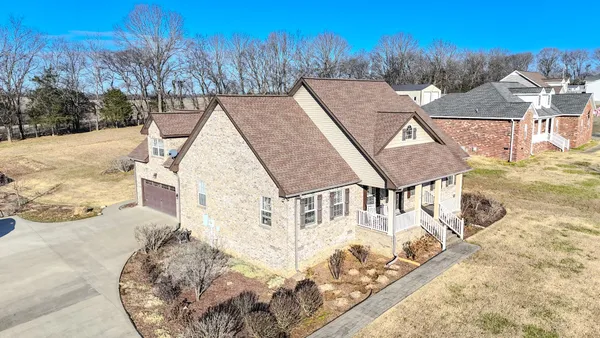 a view of a house with a yard covered in snow