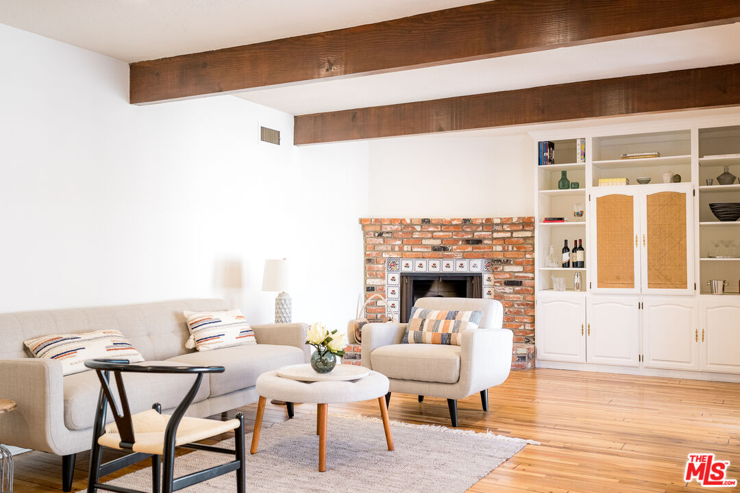 5849 Goodland Avenue Valley Village, CA 91607 - Photo 11 of 25 a living room with furniture a fireplace and wooden floor