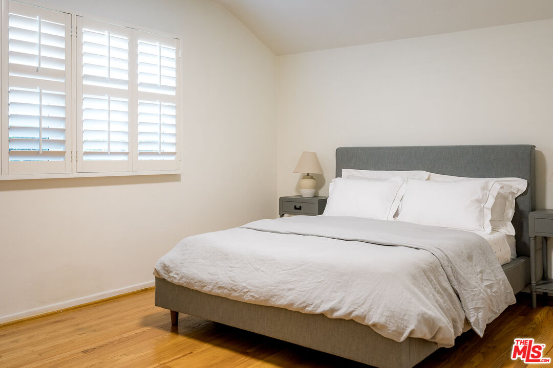 5849 Goodland Avenue Valley Village, CA 91607 - Photo 14 of 25 a large bed sitting in a bedroom next to a window