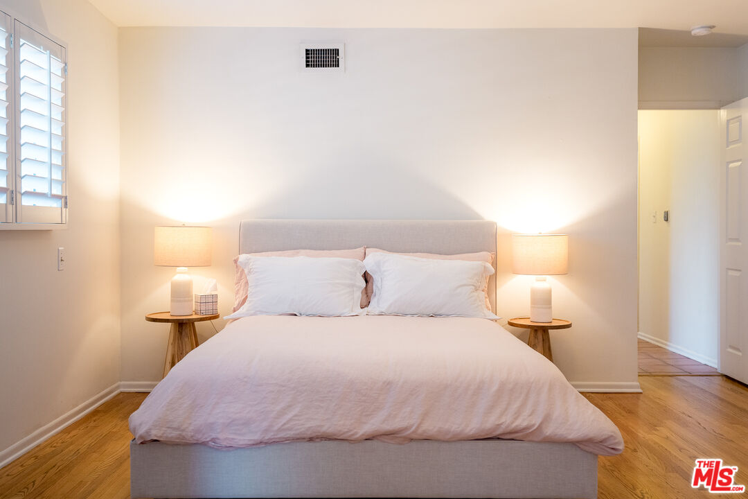 5849 Goodland Avenue Valley Village, CA 91607 - Photo 15 of 25 a bedroom with a bed and lamps